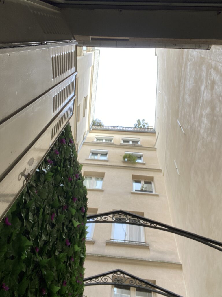 Une cour intérieure achemine la lumière du ciel jusque sur la terrasse d'un studio qui reste sombre